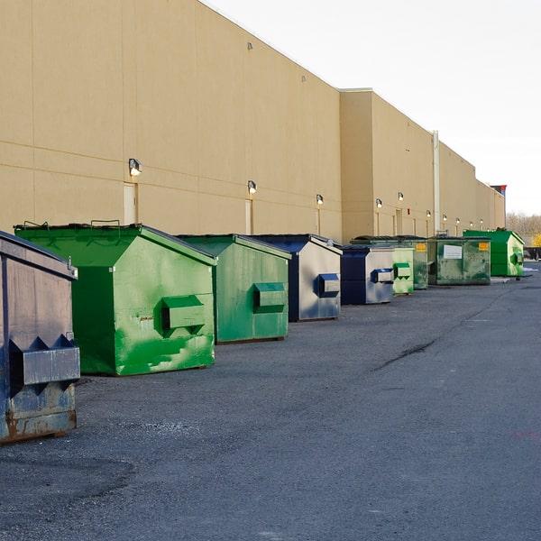 large green commercial waste container parked outside a restaurant